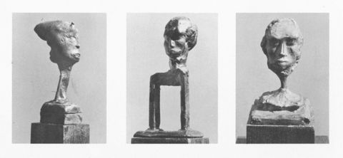 Page of an exhibition catalogue. Three black and white photographs on a white page show different bronze sculptures that distort the human head. The work to our left has a long, ribbon-like neck. The next sits on a shape like a long staple. The third has a head supported on an incongruously spindly neck.